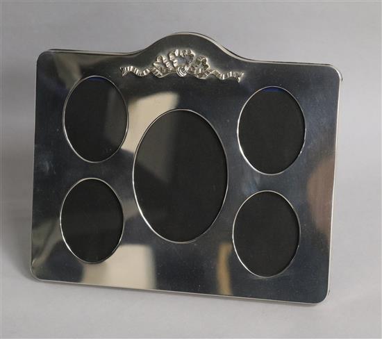A modern silver mounted photograph frame with five oval apertures, London, 1989, width 21.7cm.